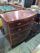 An antique mahogany bow fronted chest having 2 short and 3 long drawers