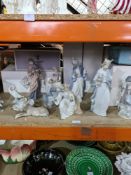 A quantity of Lladro and Nao figures, the Nao examples being religious gentlemen