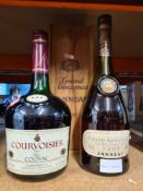 A bottle of Janneau Grand Armagnac in wooden case and a one litre bottle of Courvoisier