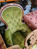 A Victorian mahogany fireside armchair having button back