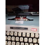 A vintage Brother typewriter and a box of various Bristol glasses