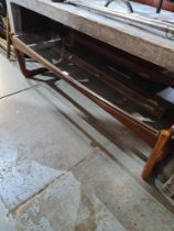 A 1970s teak oblong coffee table having glass top, 127cm