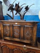 A reproduction oak coffer having carved panel front 93cm