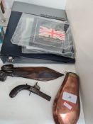 An antique flintlock pistol, a copper powder flask and a small quantity of uncirculated coins