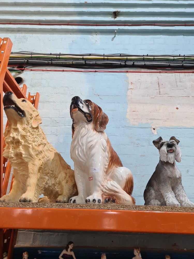 A large Italian pottery figure of seated St Bernard dog and 2 other resin dogs