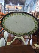 A Georgian style painted oval table decorated Ivy