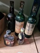 A small bottle of Sake, two partial bottles of Chateau Baret 1984 and others (5)