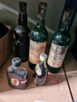A small bottle of Sake, two partial bottles of Chateau Baret 1984 and others (5)