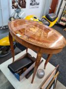 A reproduction Italian inlaid musical table of oval form