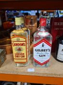 Two x 1 Litre bottles Gilbey's gin, 2 x 1 Litre bottles of Gordon's and 3 other bottles of alcohol