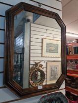 A carved oak barometer and an oak wall mirror