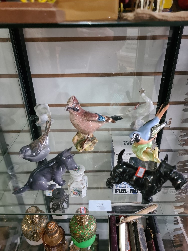 A Royal Copenhagen Scottie Dog, a Doulton example and 5 bird figures