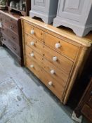 An antique pine chest having 2 short and 3 long drawers, with bamboo style Corinth sides, 113cm