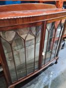 A mahogany bow fronted display cabinet on Cabriole legs