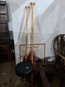 Two boat oars, manufactured by Grey Owl, Canada, a music stool and a poster