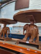 Two oval coffee tables, having carved elephant supports, the largest 51cm high