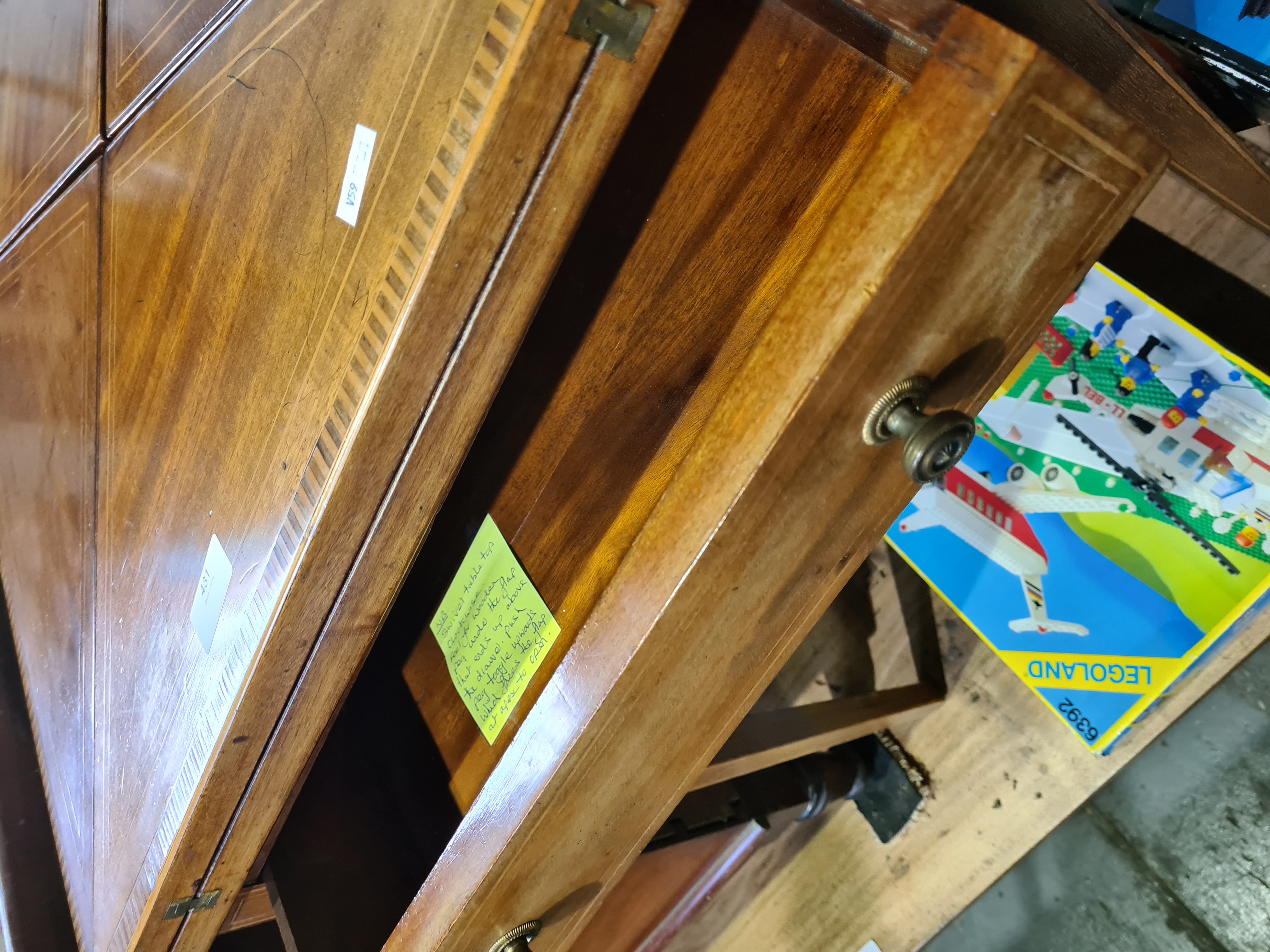 An Edwardian mahogany inlaid envelope card table having one drawer