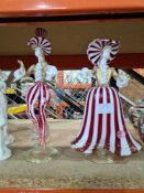 A pair of vintage Murano glass figures having red and white striped decoration with original labels,