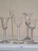 An antique air twist wine glass, 3 others and a similar candlestick