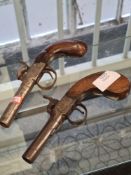 Two small antique percussion pistols with mahogany handles both triggers working