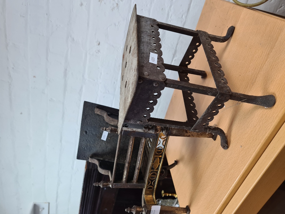 An iron and brass model fireplace and trivet