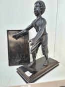 An antique carved wooden figure of Caribbean man holding tray