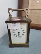 A modern brass carriage clock having enamelled dial
