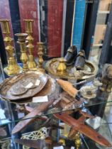 A selection of mixed metalware including brass candlesticks, corkscrews, drinks labels, nutcrackers,