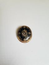 Antique yellow metal oval mourning brooch with black enamel front and 3 seed pearls, the front openi