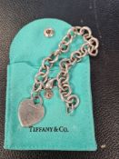 Sterling silver link bracelet hiung with heart shaped panel marked Tiffany&Co 925, in pouch