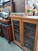 Two display cabinets and a veneered oval dressing table mirror
