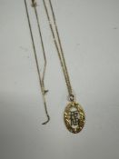 9ct yellow gold fine neckchain hung with a 9ct oval pendant depicting character marks and another 9c