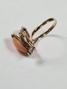 14K yellow gold dress ring set with cabouchon coral and 2 small round cut diamonds, marked 14K, size