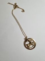 Unmarked yellow gold neckchain hung with a circular 9ct gold pendant depicting a goat, marked 375, 6