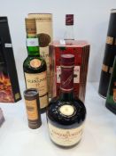 A 70cl bottle of Glenlivet Whisky, single malt in cardboard tube, a bottle of Courvoisier Cognac and