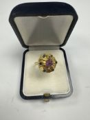 18ct yellow gold dress ring with raised gold panel inset with rubies and sapphires, size P, marked 7