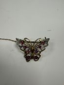 Pretty 9ct yellow gold butterfly brooch inset with 8 round cut rubies and each wing tipped with diam