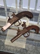 Two small antique flintlock pistols one engraved Thomas, London