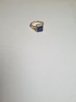 9ct yellow gold dress ring set with princess cut sapphire surrounded diamond chips, marked 375, mark