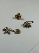 3 9ct gold charms, a cow, pig and hot water bottle, and a dress stud, 3.45 gross