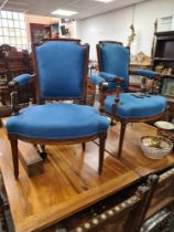 A pair of French style elbow chairs, upholstered in blue