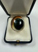 An unusual gold dress ring with oval cabouchon hardstone on gold mount, size J, 10.5g