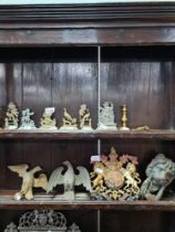 A cast metal crest from Queen's building and a selection of brass depicting cupids, animals and bird