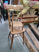 A country made vintage wooden high chair plus a miniature rush seated little chair, with turned spin