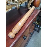 A heavy hand turned wooden rolling pin of large proportions