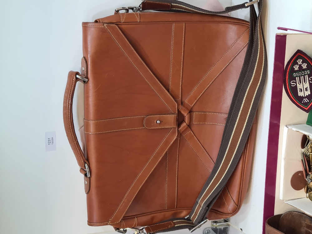 A modern tan leather satchel with shoulder strap, having internal Mulberry label