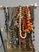 Quantity of vintage and modern necklaces, mostly bead examples, all hung on Dowell,