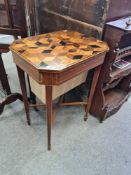 An antique mahogany sewing table, having parquetry lid, on square tapered legs