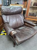 A vintage 70s Parker Knoll style brown leather revolving chair