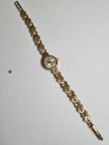 Attractive 9ct gold cased ladies cocktail watch with champagne dial and gold baton markers, signed '